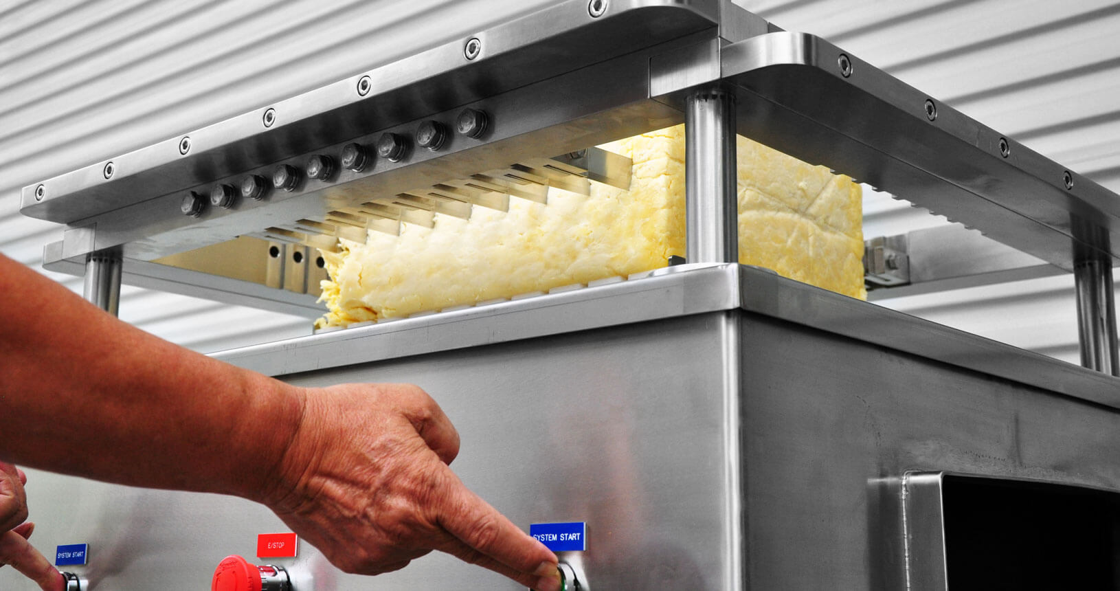A cutting machine to divide a single processed cheese block into smaller cubes or blocks.